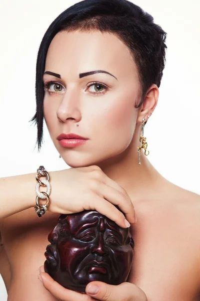 Young beautiful brunette girl with asymmetrical hairstyle in jewelry design — Stock Photo, Image