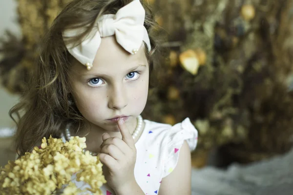 Beautiful little girl with a rim in the form of a bow — Stock Photo, Image