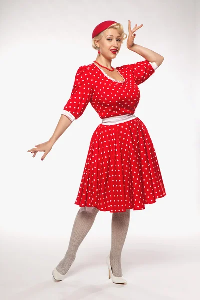 Young beautiful blonde in red dress pin-up in the studio — Stock Photo, Image