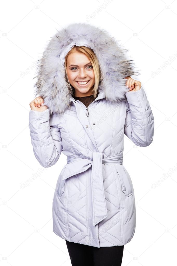 Young beautiful blonde girl in a white coat with fur collar
