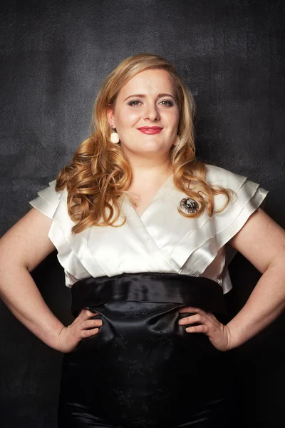 Young beautiful full-bodied blonde woman in a black and white vintage dress — Stock Image Young beautiful full-bodied blonde woman in a black and white vintage dress Royalty Free Stock Photos