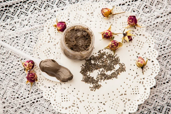 Handmade scrub in clear glass jar on a lace tablecloth — Stock Photo, Image