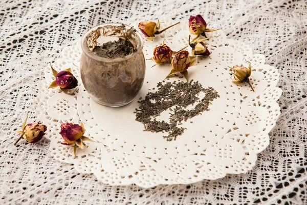 Esfoliação artesanal em frasco de vidro transparente em uma toalha de mesa de renda — Fotografia de Stock