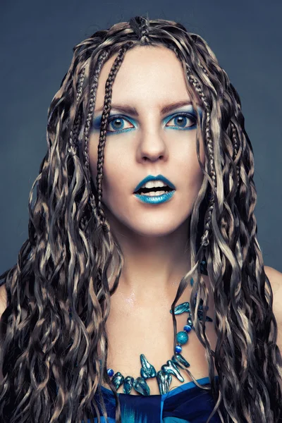 Young girl with long African braids in a blue dress — Stock Photo, Image