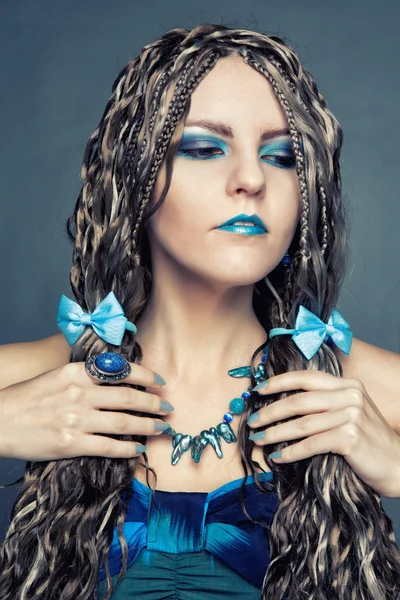 Young girl with long African braids in a blue dress — Stock Photo, Image