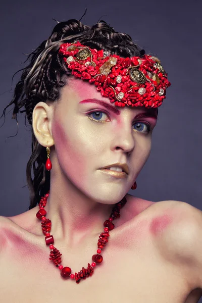 Jeune fille en boucles d'oreilles et colliers de corail rouge — Photo