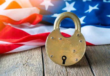 No entry to America and homeland security concept with big padlock and USA Flag on the backdrop clipart