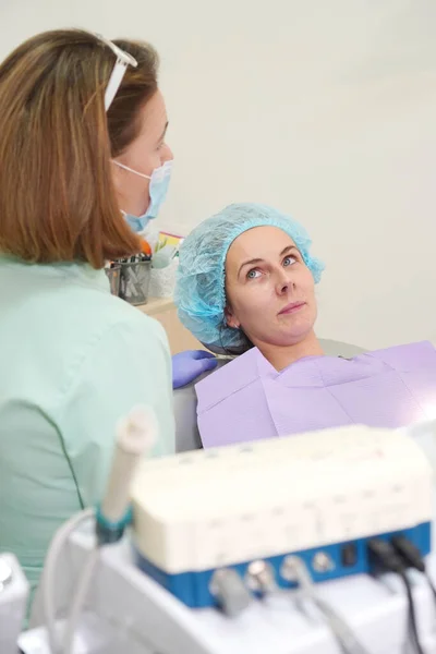 Dentist doctor consults a patient. Vertical background.