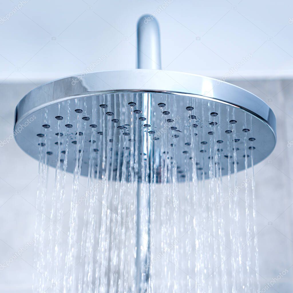 Shower system. Shower head and water falling closeup.