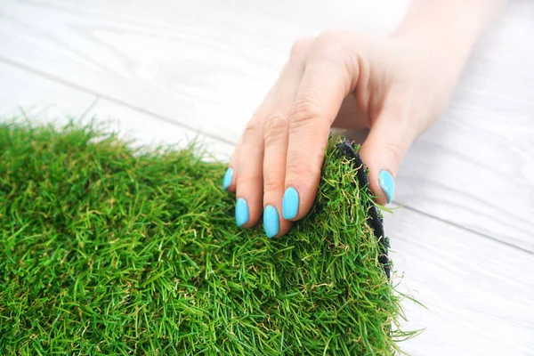 Tender Female Hand Touching Artificial Grass Roll — Stock Photo, Image