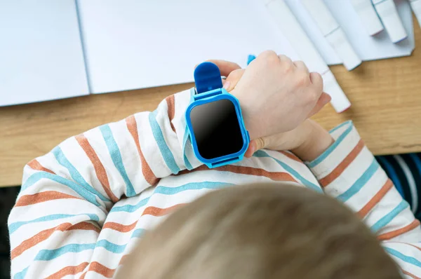 Smart baby watches with wiretapping, remote monitoring and GPS tracker on the children's hand.