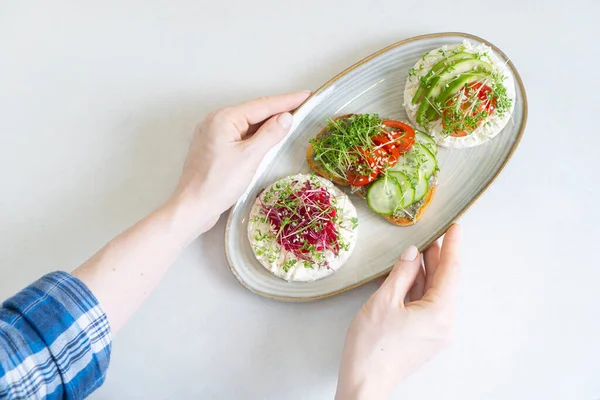 Female Hands Holding Plate Toasts Made Fresh Microgreen Sprouts View — Stock Photo, Image