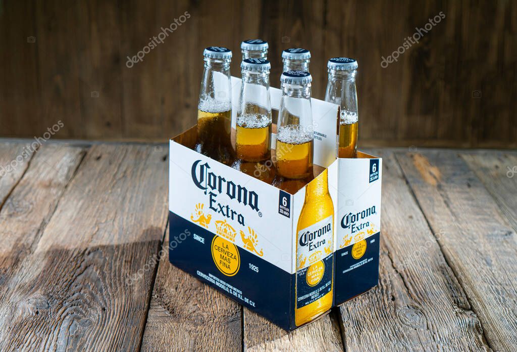 KHARKIV, UKRAINE - 30 June, 2020: Illustrative editorial of Corona Beer bottles in a package on the wooden background