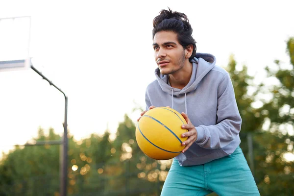 young caucasian teen boy playing basketball