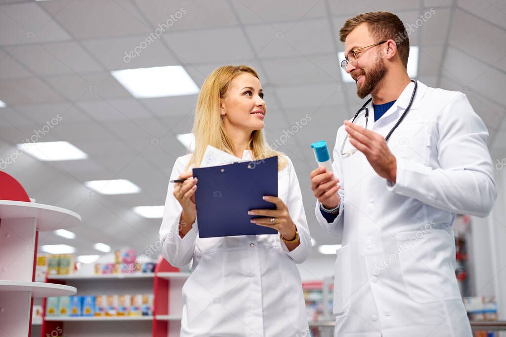 team of chemists or druggists discussing medicines, check