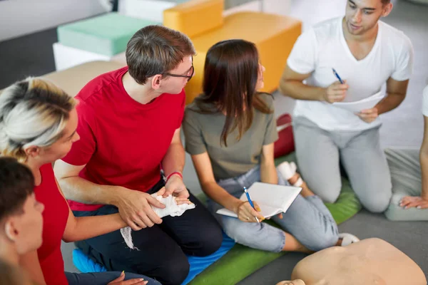 young people learning how to safe a life sitting together on lesson