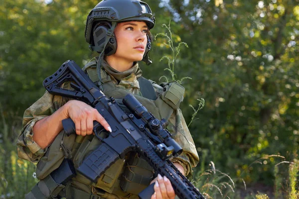 Ung kaukasisk militär kvinna håller en pistol i handen i naturen — Stockfoto