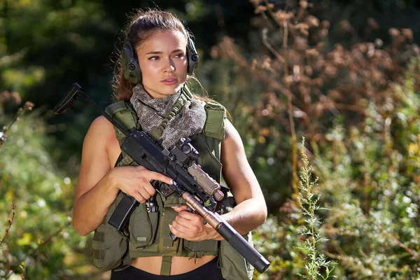 Camouflaged woman sniper in ghillie suit posing with rifle in foggy night.  Special Weapons and Woman Concept Stock Photo - Alamy