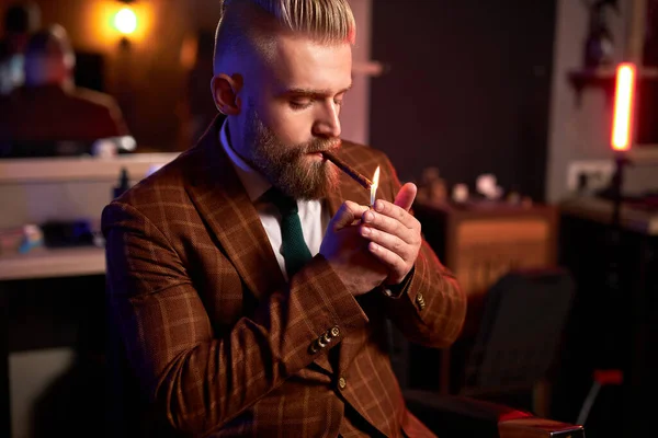 rich caucasian business man in suit smoke a cigar