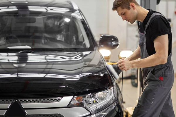 Tvrdě pracující automechanik samec je lešticí auto s použitím speciálního vybavení — Stock fotografie