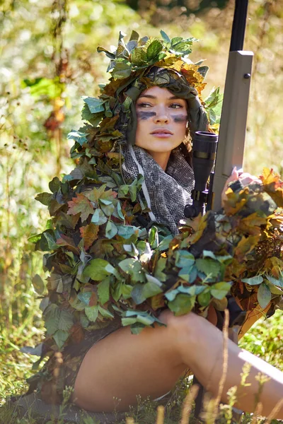 Camouflaged woman sniper in ghillie suit posing with rifle in foggy night.  Special Weapons and Woman Concept Stock Photo - Alamy