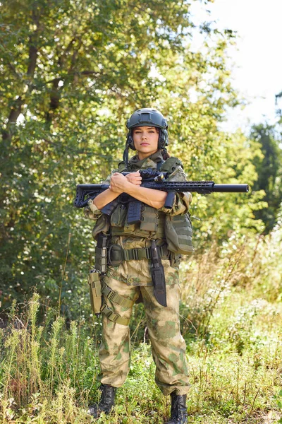 powerful sportive woman soldier ready for battle wearing protective military gear