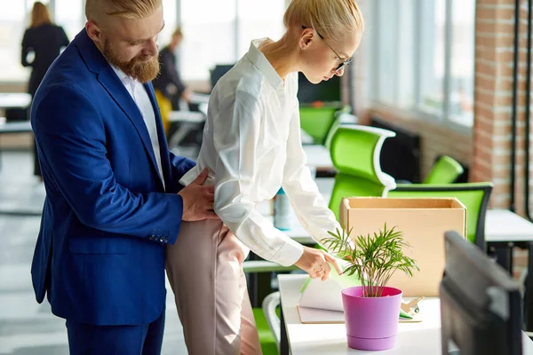 Young business man harassing office woman sexually in modern office — Stock Photo, Image