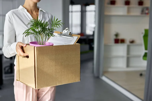 caucasian female employee intern holding cardboard box with belongings start or finish job