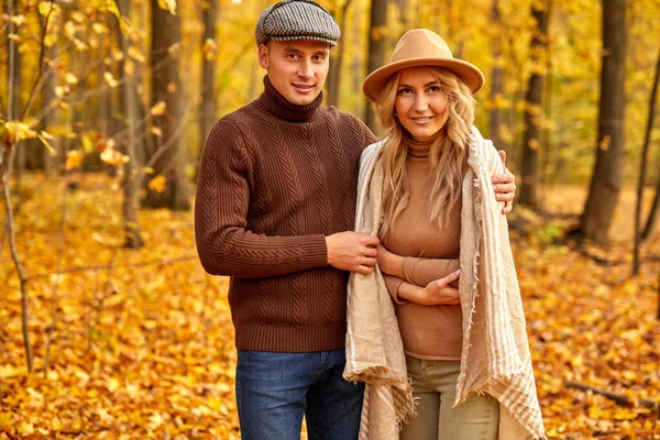 Couple marié en vêtements de style automne marcher à l'extérieur dans la forêt d'automne — Photo