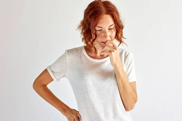 Lasst uns nachdenken. Zweifelhafte Frauen stehen in Besinnung und blicken nach unten — Stockfoto