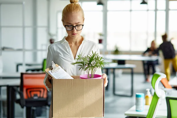 caucasian female employee intern holding cardboard box with belongings start or finish job