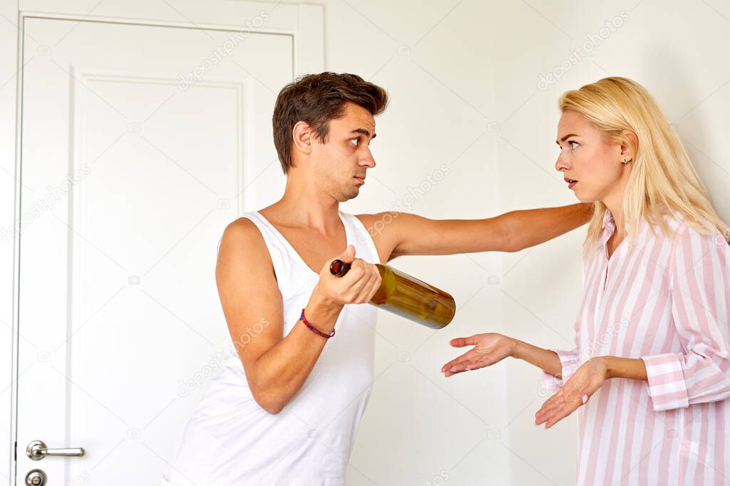 alcohol addict man and woman sort things out at home