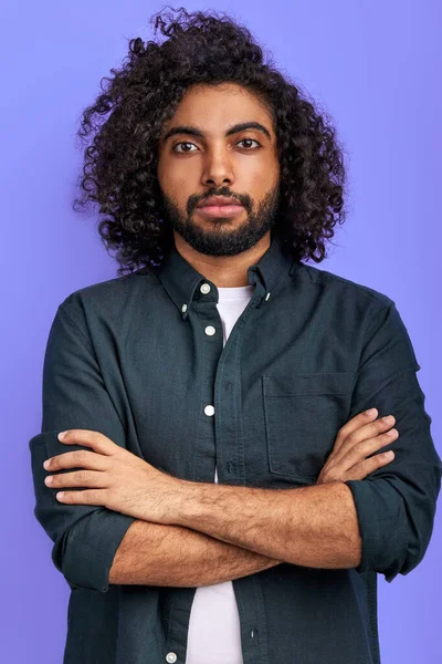 cool curly arabic guy posing at camera