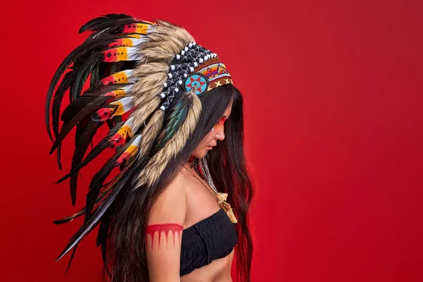 Calm long haired shaman woman with feathers on head — Stock Photo, Image