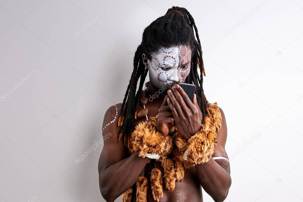 shocked native african man studying mobile phone
