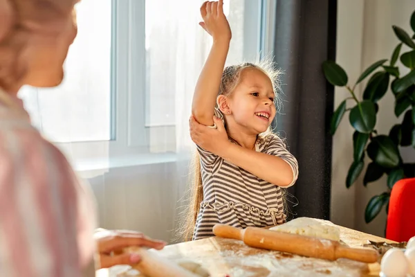 子供の女の子は調理する前に袖を包む — ストック写真