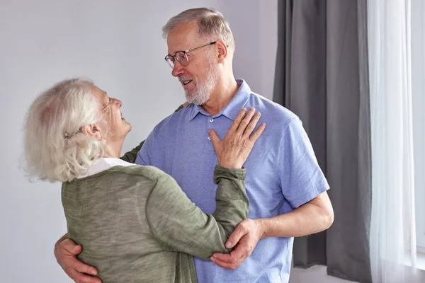 Happy senior couple have fun dancing at home — Stok fotoğraf