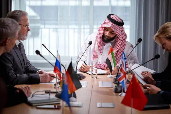 Multi-ethnic business entities gathered together for negotiating meeting lead by Arabian businessman — Stockfoto