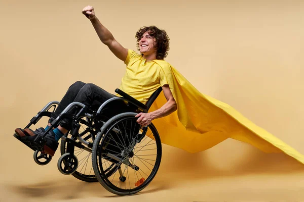 stock image portrait happy disabled caucasian man in yellow cloak pretend to be superhero