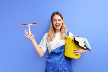 Temizlik malzemeleriyle ağlayan kadın çığlık atıyor.