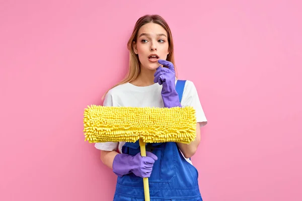 Pensive caucasian woman with mop in hands going to clean, wash the floor — Stock Photo, Image