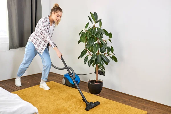Rumah tangga, pekerjaan rumah tangga dan konsep pembersihan. wanita muda atau ibu rumah tangga dengan vacuum cleaner di rumah — Stok Foto