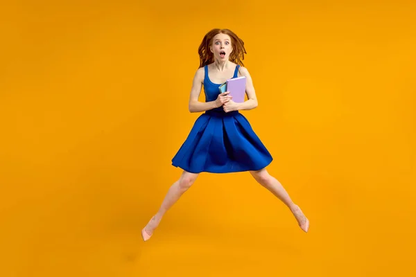 Crazy amazed teacher woman in blue dress holding books in hands, in shock by pupils — Stock Photo, Image