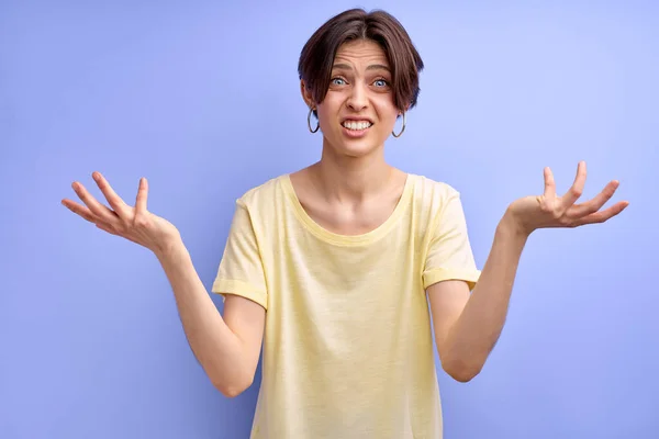 What the hell. short haired female spreading arms, emotionally reacts at something — Stock fotografie