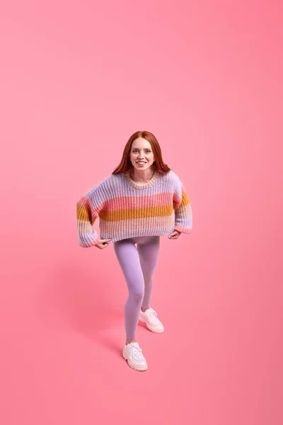 Excited funny redhead woman in casual wear have fun alone in studio, posing at camera — Stock Photo, Image