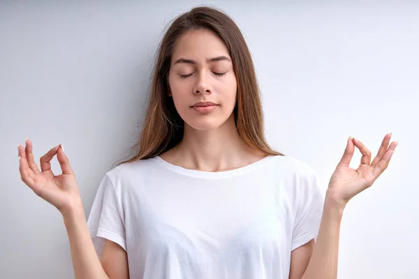 Calm caucasian woman keep calm, meditating with eyes closed, isolated on white — Stock Photo, Image