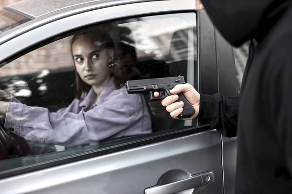 Bandido ladrón hombre sosteniendo arma de mano gángster para secuestrar rehén mujer conductor coche —  Fotos de Stock