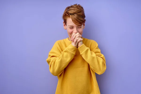 Adorable shy boy keep hands together, dreaming, stands with eyes closed. isolated — Stock Photo, Image