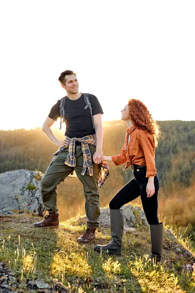 Giovane coppia caucasica in escursione. escursionisti entusiasti uomini e donne che si tengono per mano — Foto Stock