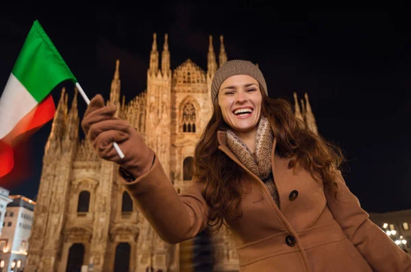 Donna sorridente che sventola bandiera italiana vicino al Duomo in serata, Milano — Foto Stock